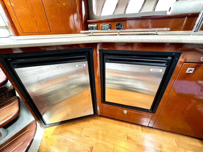 Slide: The Image of Luxurious 2010 Sea Ray 40 Sundancer yacht interior with stainless steel appliances and wooden cabinetry. - 30