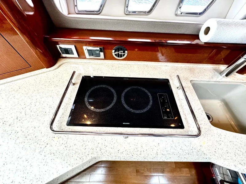 Slide: The Image of Modern kitchen area on 2010 Sea Ray 40 Sundancer yacht with stovetop and sink. - 31