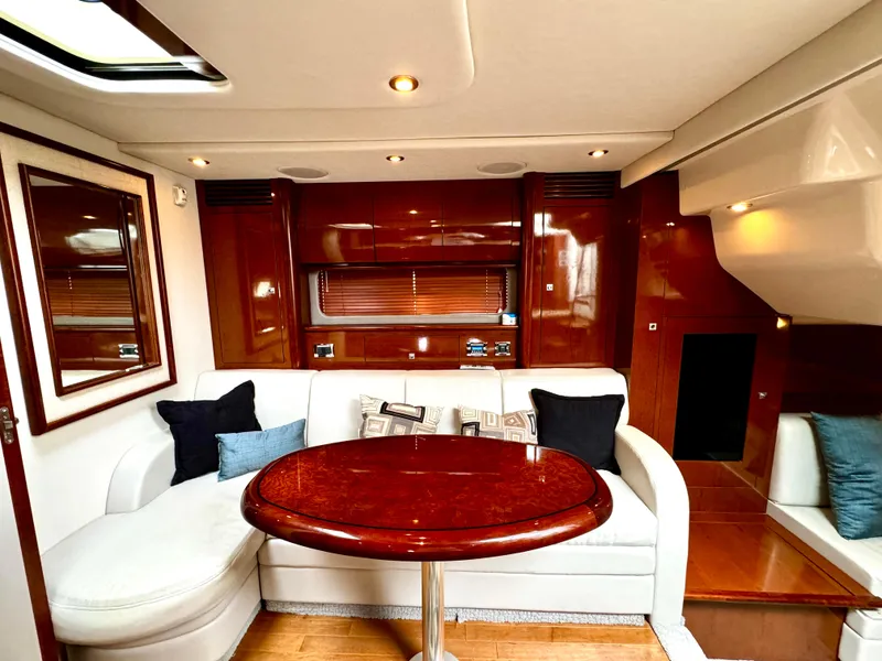 Slide: The Image of Luxurious interior of 2010 Sea Ray 40 Sundancer yacht with elegant seating and wooden finishes. - 32
