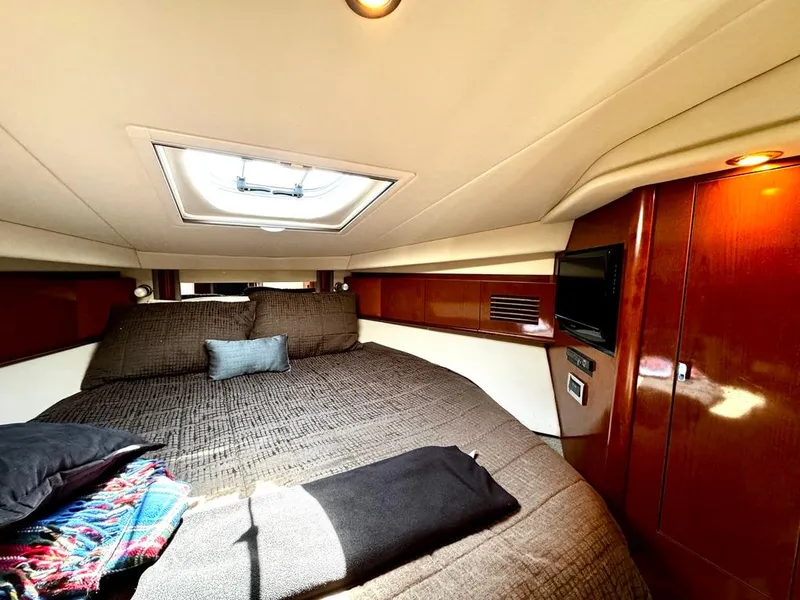Slide: The Image of Luxurious cabin interior of 2010 Sea Ray 40 Sundancer yacht with skylight and cozy bedding. - 38