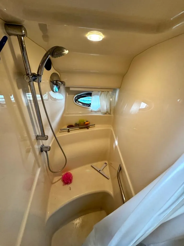 Slide: The Image of Shower area in 2010 Sea Ray 40 Sundancer yacht with modern fixtures and porthole window. - 39