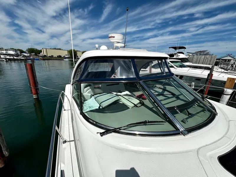 Slide: The Image of 2010 Sea Ray 40 Sundancer yacht docked in marina under blue sky. - 4