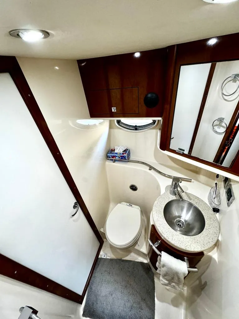 Slide: The Image of 2010 Sea Ray 40 Sundancer bathroom with modern fixtures and compact design. - 40