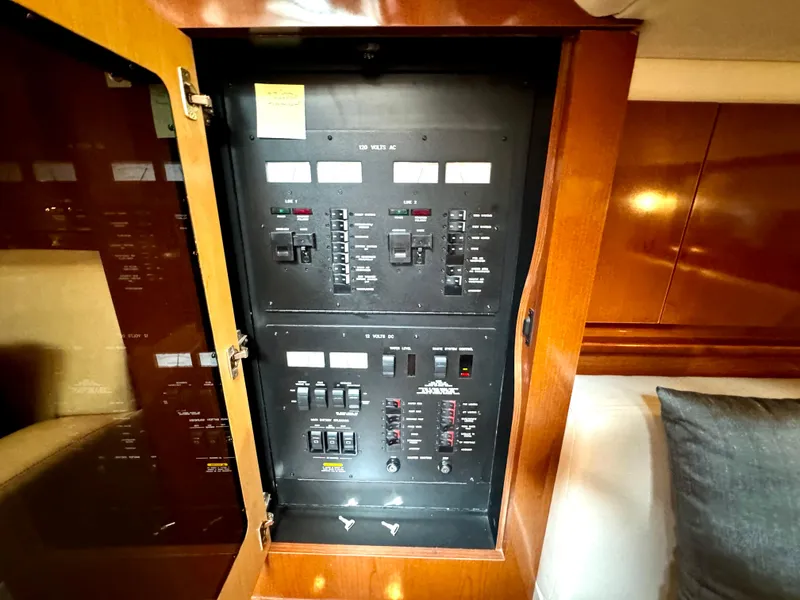 Slide: The Image of Electrical panel inside 2010 Sea Ray 40 Sundancer yacht, featuring switches and controls. - 41