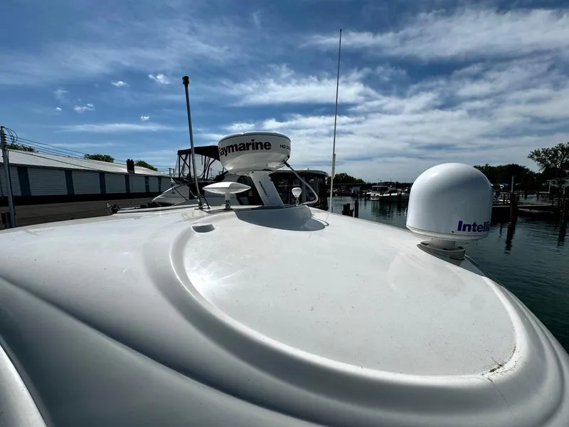 Slide: The Image of 2010 Sea Ray 40 Sundancer yacht with radar equipment, docked under a clear sky. - 7