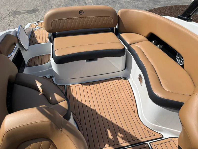 Slide: The Image of 2024 Crownline Eclipse E255 boat interior with tan leather seating and wood-style flooring. - 10