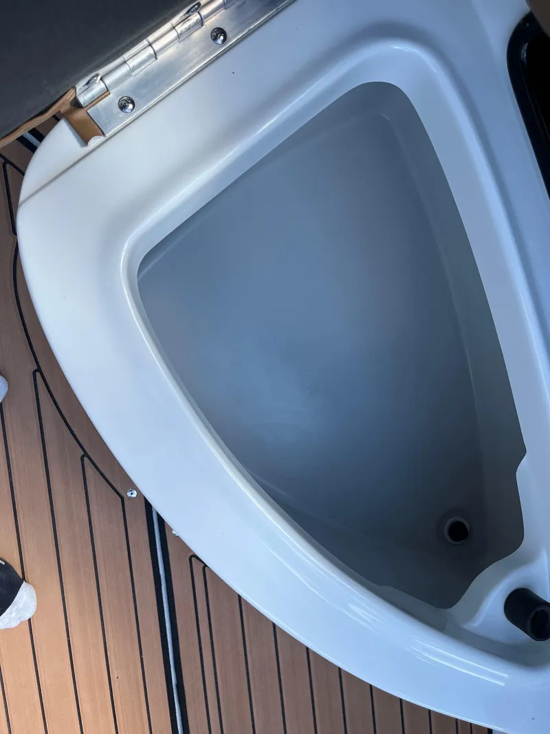 Slide: The Image of 2024 Crownline Eclipse E255 boat storage compartment with teak flooring. - 17