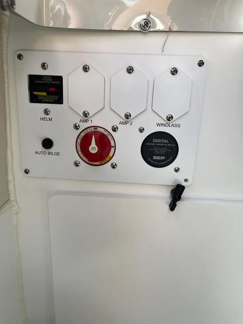 Slide: The Image of 2024 Crownline Eclipse E255 control panel with switches and digital display. - 19