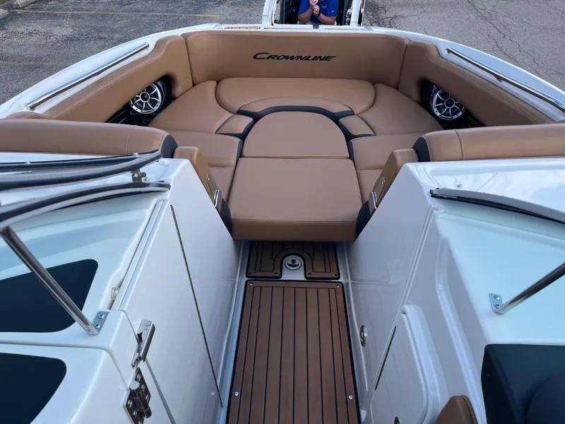 Slide: The Image of 2024 Crownline Eclipse E255 boat interior with tan seating and wood flooring. - 4
