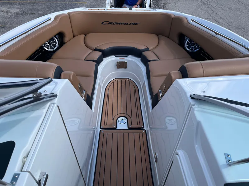 Slide: The Image of 2024 Crownline Eclipse E255 boat interior with tan seating and wood accents. - 5