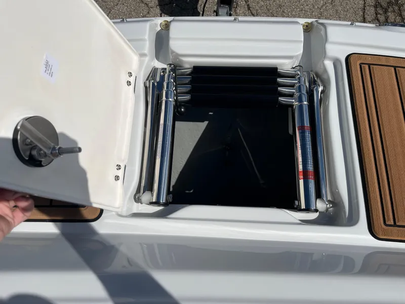 Slide: The Image of 2024 Crownline Eclipse E255 boat ladder compartment with open hatch. - 7