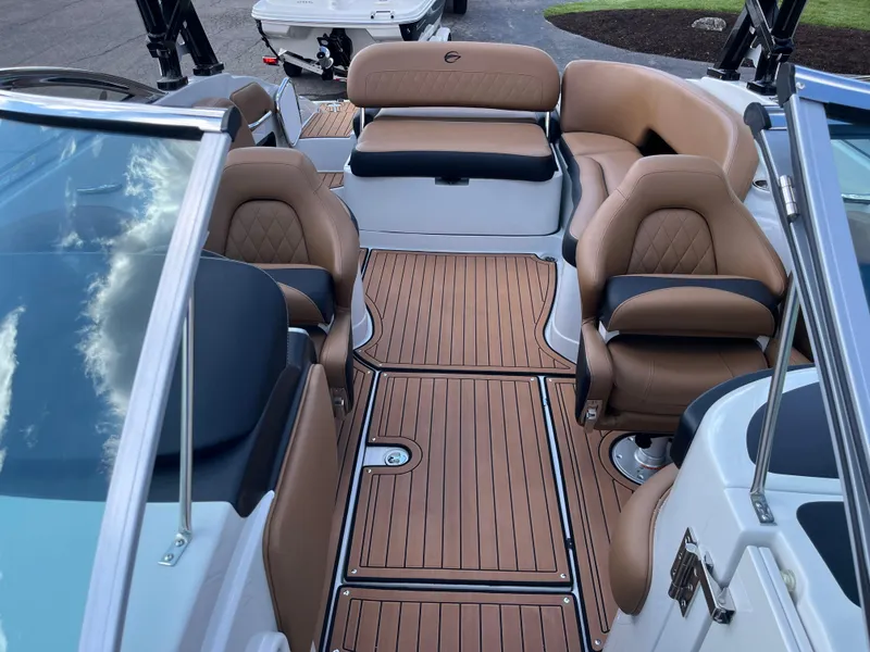 Slide: The Image of 2024 Crownline Eclipse E255 boat interior with luxurious seating and teak flooring. - 8