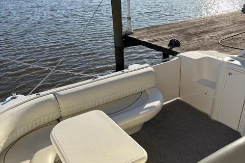 Slide: The Image of 1998 Cruisers 3870 Express boat interior with seating and table by the water. - 14