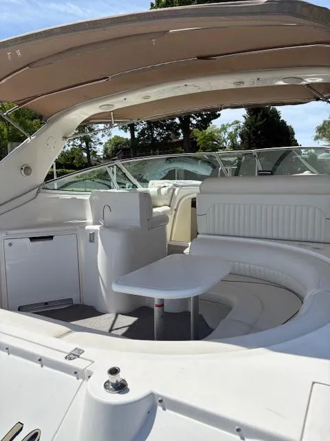 Slide: The Image of 1998 Cruisers 3870 Express yacht interior with seating and table under canopy. - 15