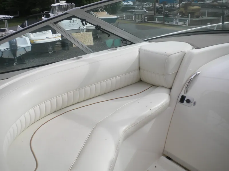 Slide: The Image of 1998 Cruisers 3870 Express boat interior with white leather seating and windshield view. - 38