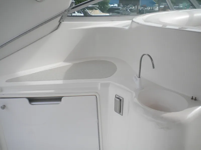 Slide: The Image of 1998 Cruisers 3870 Express yacht interior with sink and storage compartment. - 39