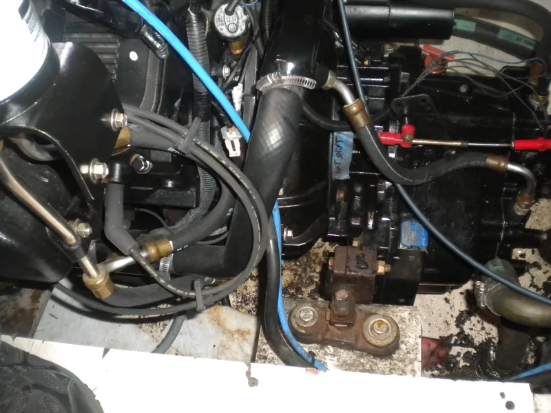 Slide: The Image of Engine compartment of a 1998 Cruisers 3870 Express boat, showing hoses and components. - 44