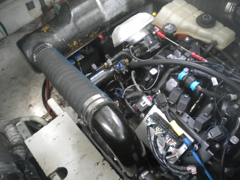 Slide: The Image of Engine compartment of a 1998 Cruisers 3870 Express boat, showing various components and wiring. - 48