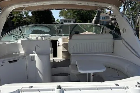 Slide: The Image of 1998 Cruisers 3870 Express yacht interior with white seating and table. - 11