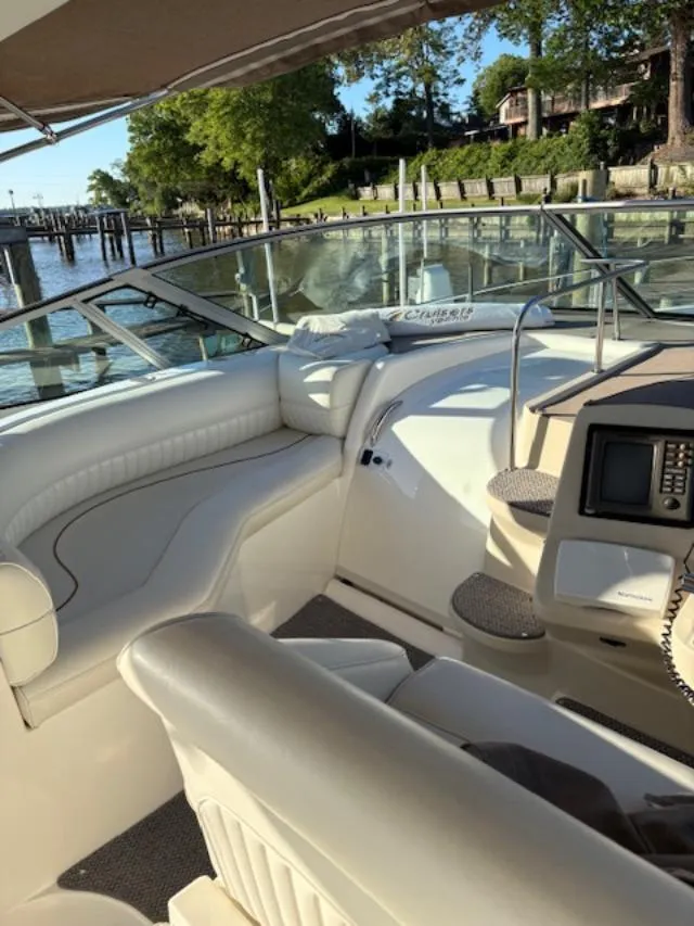Slide: The Image of 1998 Cruisers 3870 Express boat interior with white seating and navigation equipment. - 13