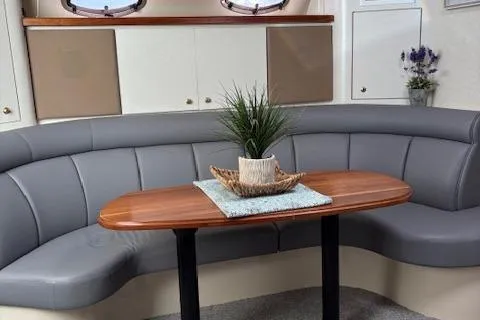 Slide: The Image of Interior of 1998 Cruisers 3870 Express with curved seating and wooden table. - 21