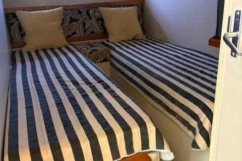 Slide: The Image of Twin beds with striped bedding in 1998 Cruisers 3870 Express cabin. - 25