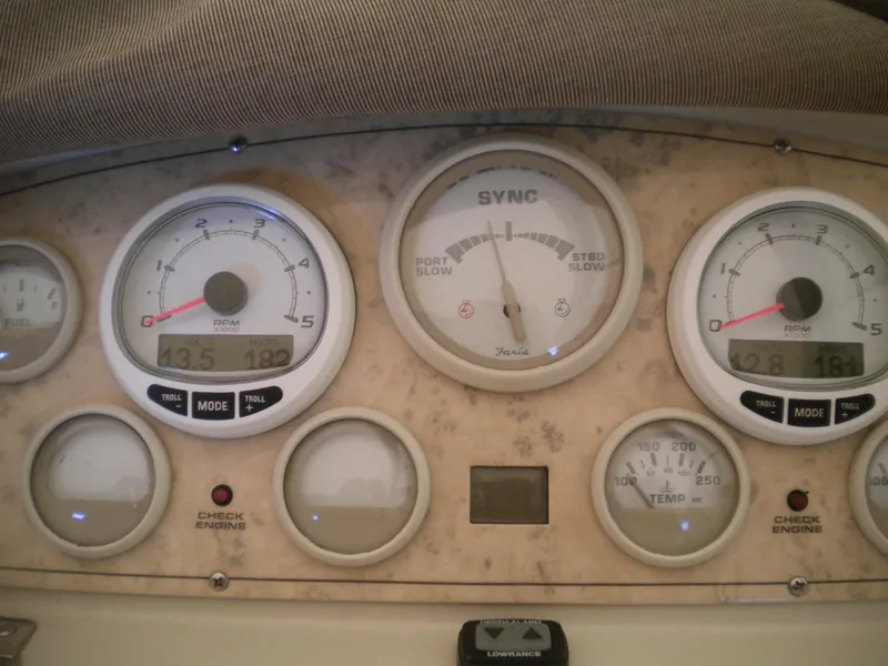 Slide: The Image of Dashboard of a 1998 Cruisers 3870 Express boat with various gauges and indicators. - 31