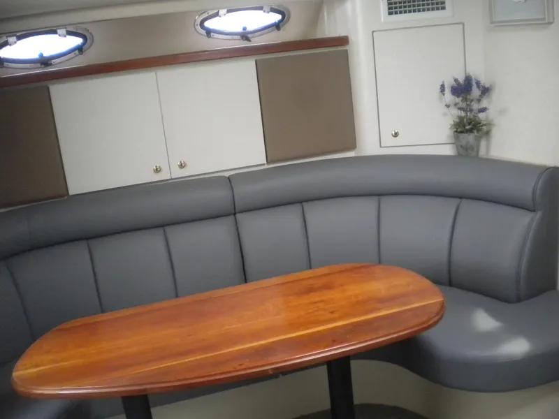 Slide: The Image of 1998 Cruisers 3870 Express interior with curved seating and wooden table. - 35