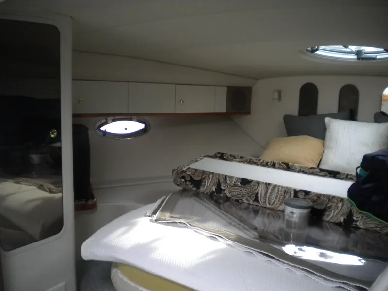 Slide: The Image of 1998 Cruisers 3870 Express cabin interior with cozy bedding and porthole window. - 36