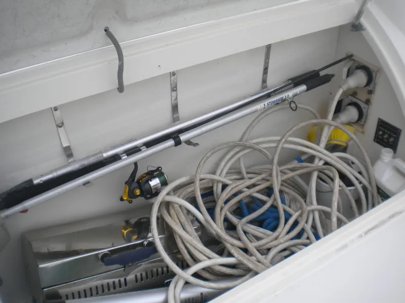 Slide: The Image of Storage compartment of 1998 Cruisers 3870 Express with fishing gear and cables. - 42