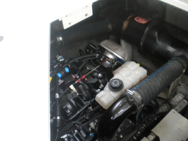 Slide: The Image of Engine compartment of a 1998 Cruisers 3870 Express boat, showcasing mechanical components. - 43