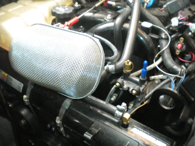 Slide: The Image of Engine components of a 1998 Cruisers 3870 Express boat, featuring hoses and wiring. - 45