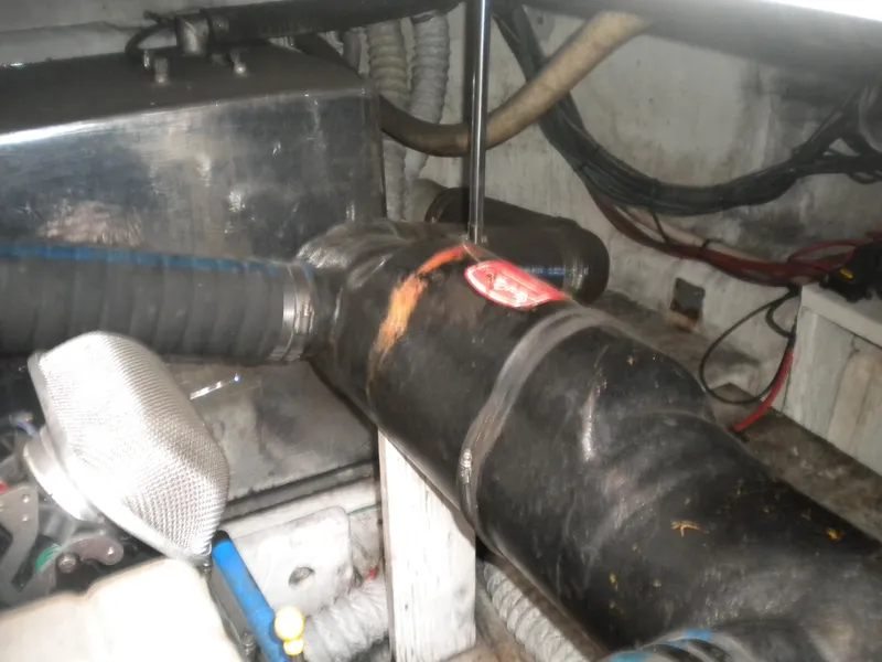 Slide: The Image of Engine compartment of a 1998 Cruisers 3870 Express boat, showing hoses and wiring. - 47