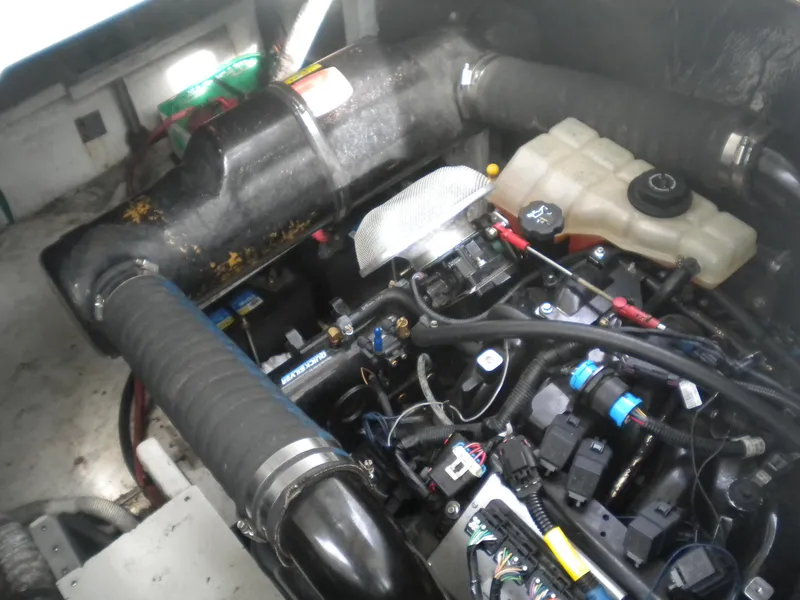 Slide: The Image of Engine compartment of a 1998 Cruisers 3870 Express boat, showing various components and wiring. - 49