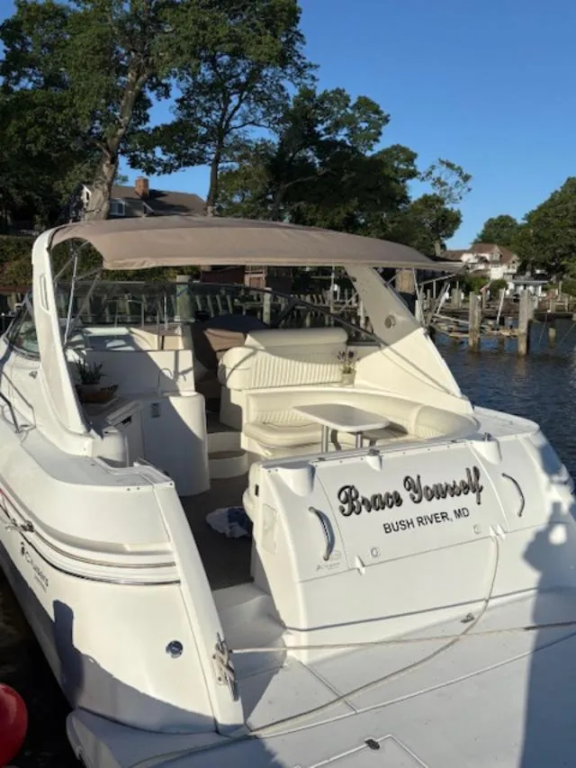 Slide: The Image of 1998 Cruisers 3870 Express yacht docked, featuring spacious seating and elegant design. - 6