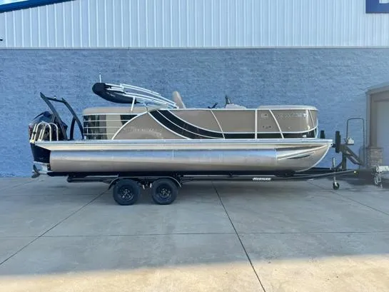 Slide: The Image of 2019 South Bay 521RS 3.0 pontoon boat on trailer, parked outside a building. - 1