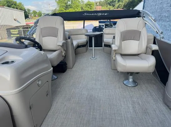 Slide: The Image of 2019 South Bay 521RS 3.0 pontoon boat interior with beige seating and steering console. - 3