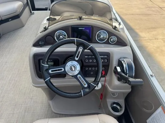 Slide: The Image of 2019 South Bay 521RS 3.0 boat dashboard with steering wheel and control panel. - 5