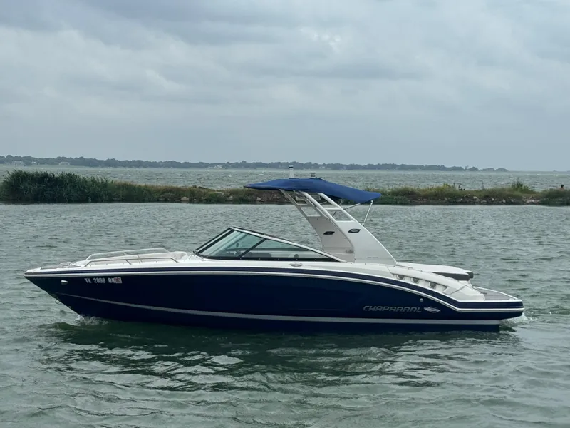 Slide: The Image of 2016 Chaparral 227 SSX boat on a calm lake under cloudy skies. - 1