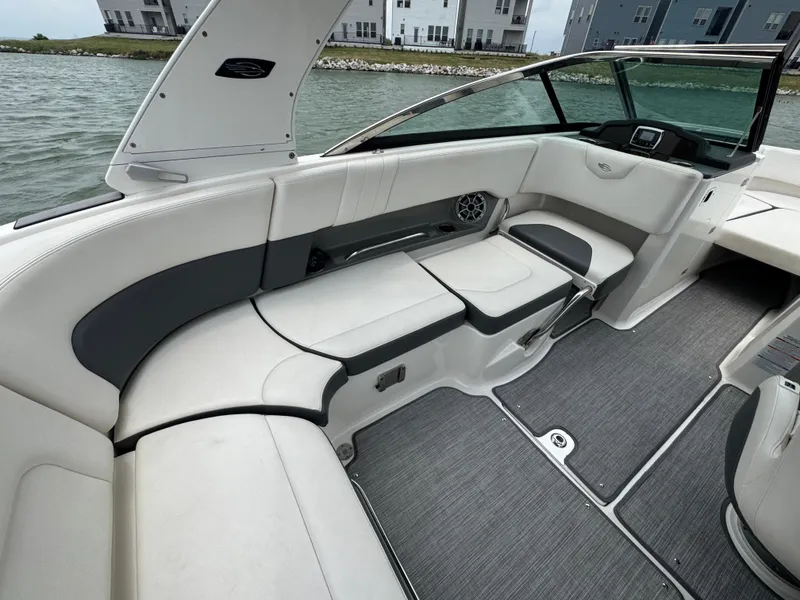 Slide: The Image of 2016 Chaparral 227 SSX boat interior with white seating and modern design. - 12