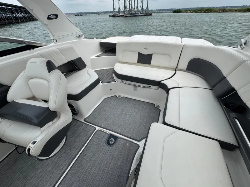 Slide: The Image of 2016 Chaparral 227 SSX boat interior with spacious seating and modern design on a lake. - 13