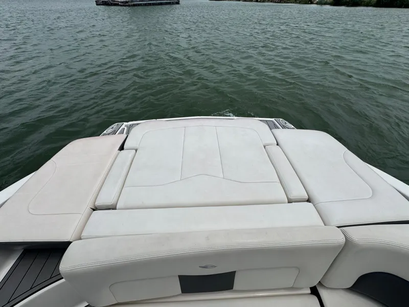 Slide: The Image of 2016 Chaparral 227 SSX boat with spacious rear seating on a calm lake. - 14