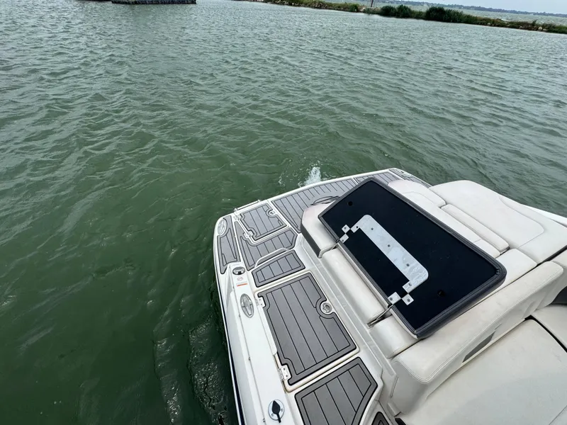 Slide: The Image of 2016 Chaparral 227 SSX boat on water, rear deck view. - 16