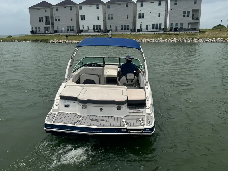 Slide: The Image of 2016 Chaparral 227 SSX boat on water near waterfront homes. - 3
