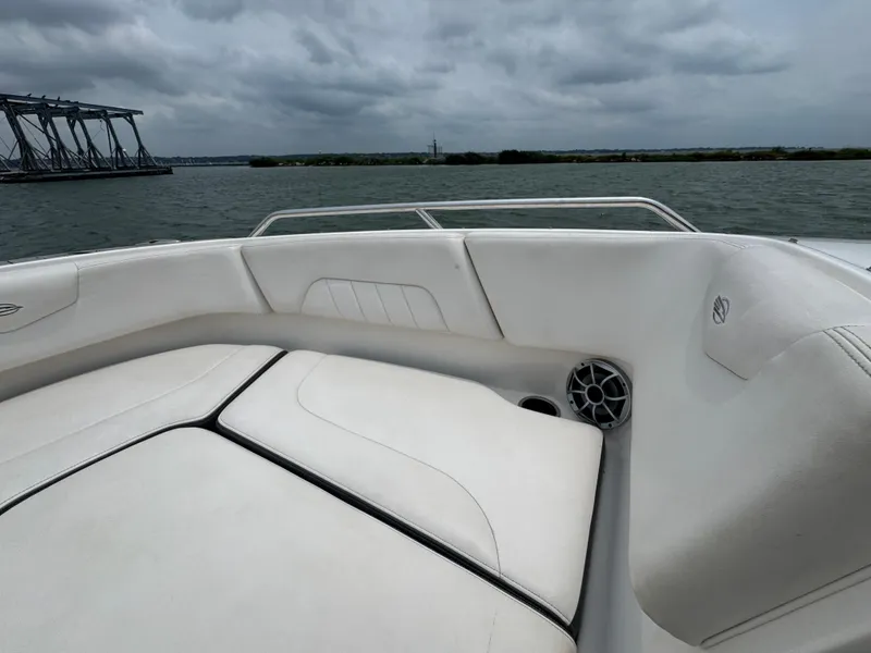 Slide: The Image of 2016 Chaparral 227 SSX boat interior with white seating, on a cloudy day. - 7