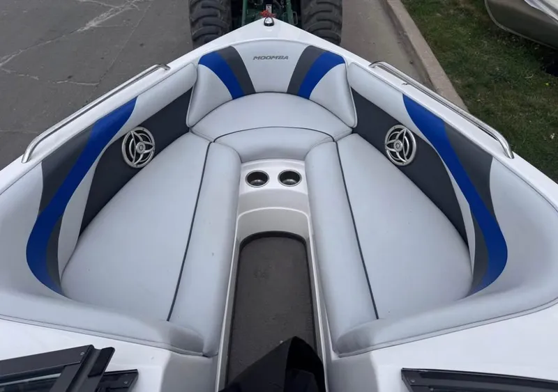 Slide: The Image of 2010 Moomba LSV boat interior with blue and gray seating and cup holders. - 11