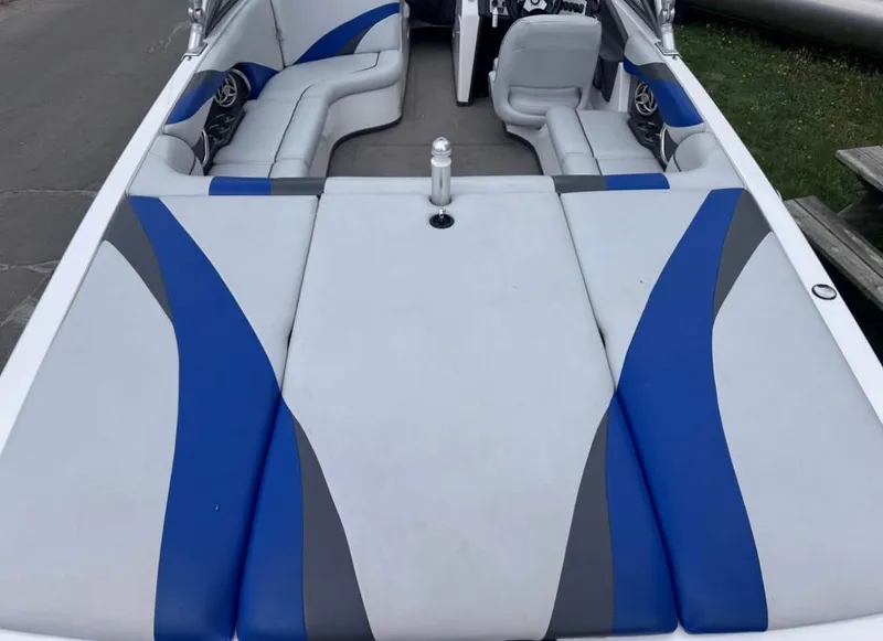 Slide: The Image of 2010 Moomba LSV boat interior with blue and gray seating, featuring a spacious layout. - 4