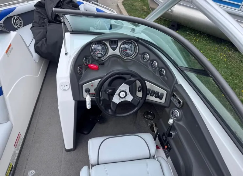 Slide: The Image of 2010 Moomba LSV boat dashboard with steering wheel and gauges. - 7