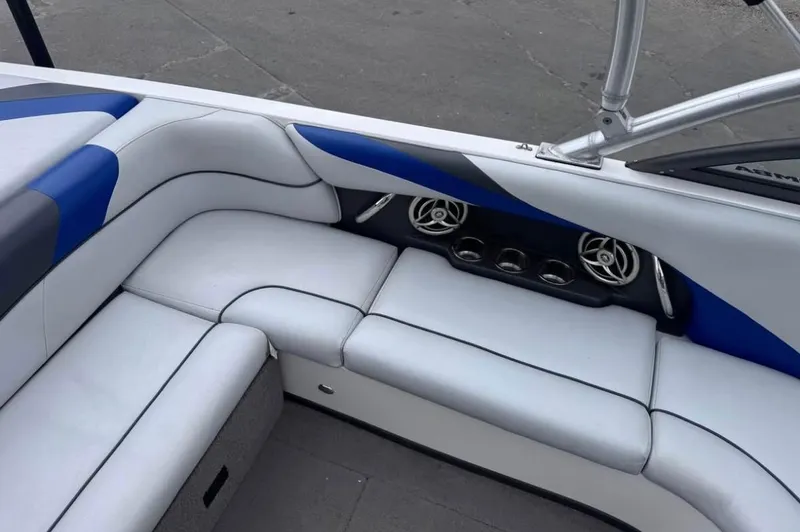 Slide: The Image of 2010 Moomba LSV boat interior with white and blue seating and built-in speakers. - 9