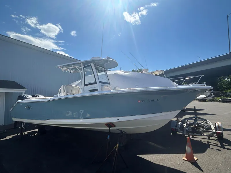 The Image of 2022 Sea Hunt Ultra 275 SE boat parked outdoors under a clear blue sky. - 0